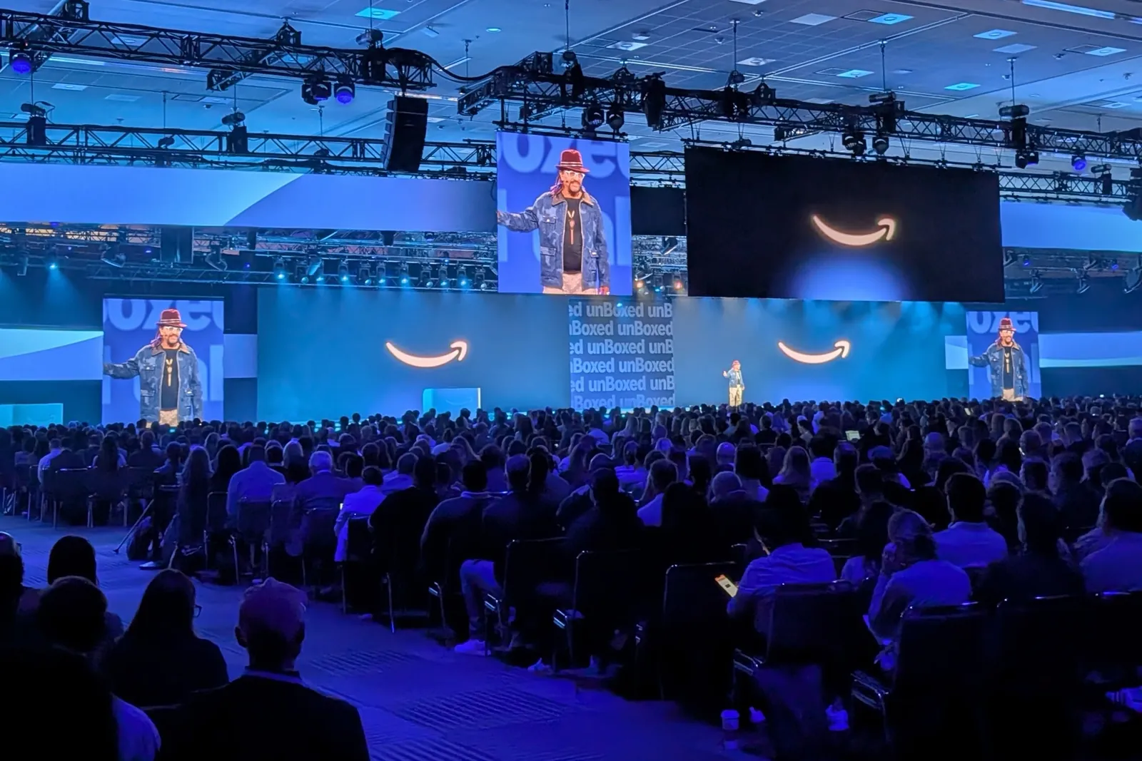 Speaker on stage at Amazon Ads unBoxed 2026, shown on the large screens above the audience